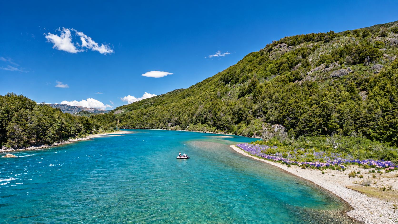 A turquoise river beside a pebble beach