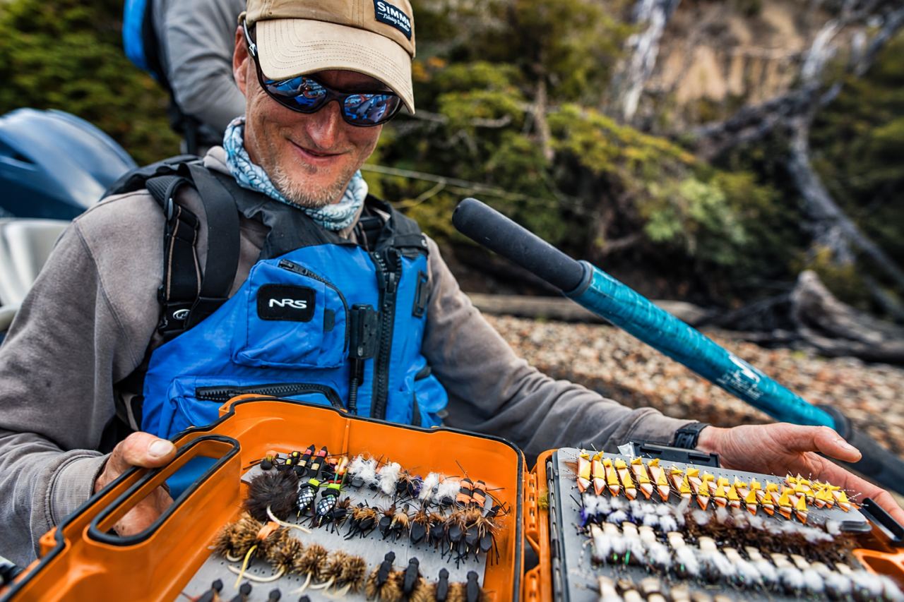 Guide opening a fly box on the raft