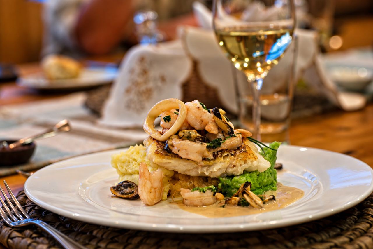 A seafood main course with a glass of white wine