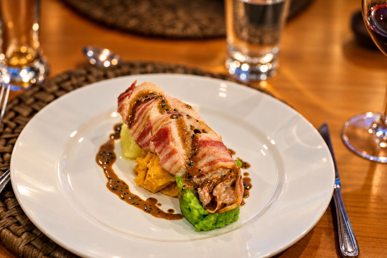 Bacon-wrapped roll plated at the dinner table
