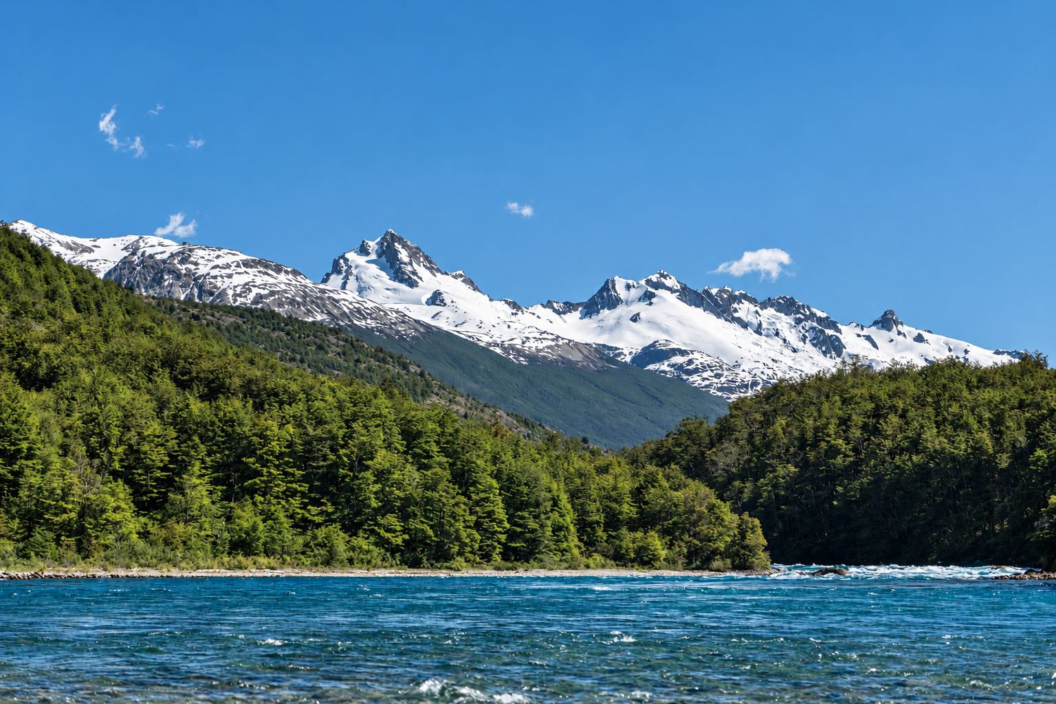 Snow peaks above a turquoise river near Baker Lodge